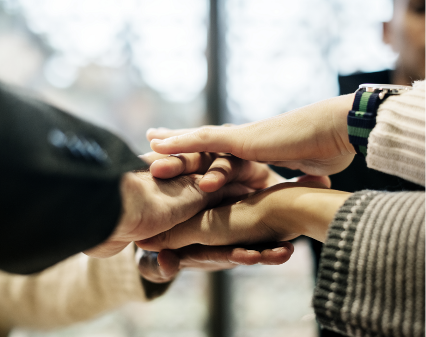 Hands of employees of shipping company , stacked one hand on top of the other symbolizing unity and joint pursuit of the goal of efficient freight forwarding services