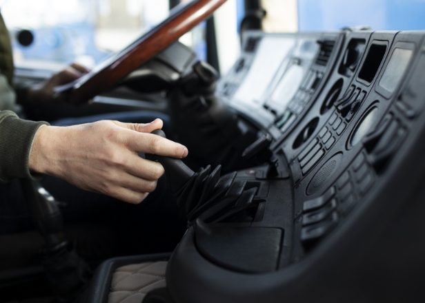 Driver operating truck controls during international freight transport